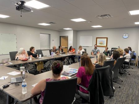 people sitting at tables for a meeting